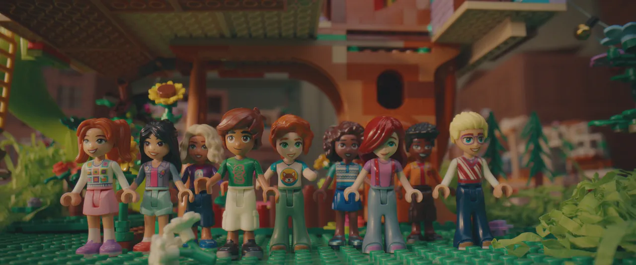 LEGO Friends minifigures standing together in a brick-built Heartlake City scene